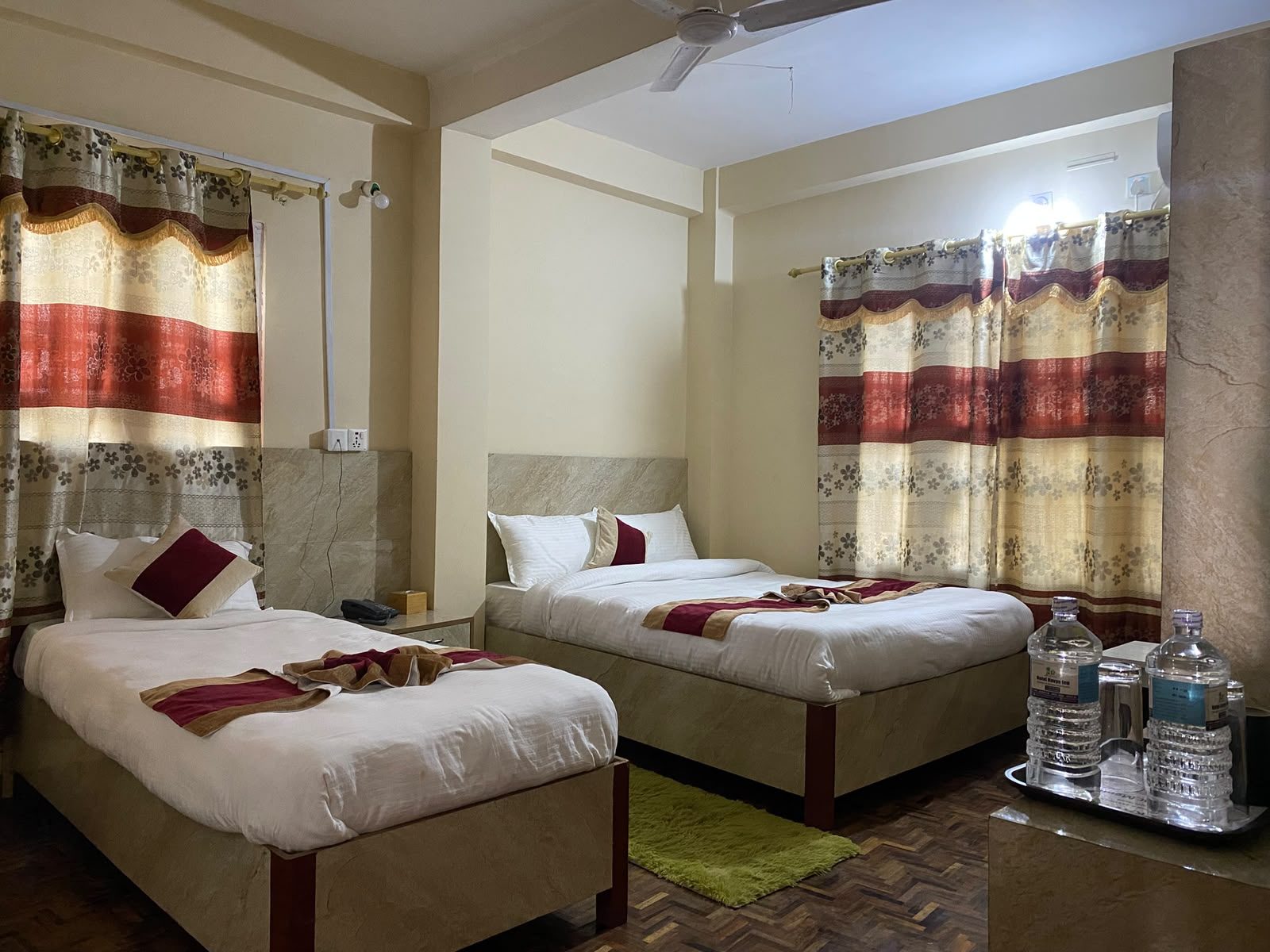 Boutique double room with mustard walls and grey curtains